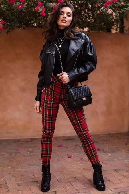 Woman in stylish red Royal Stewart plaid leggings outfit.