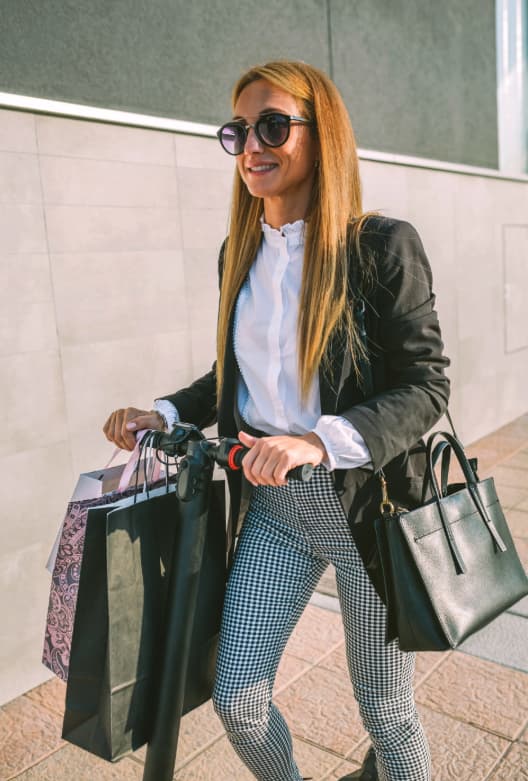 Woman riding scooter in Shepherds Border Tartan Plaid leggings