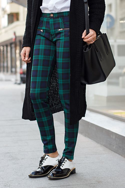 Woman in black watch plaid leggings and oxford shoes